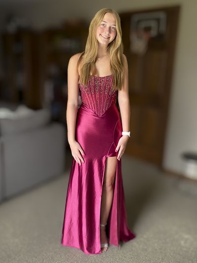 Client wearing a deep pink prom dress with a beaded bodice